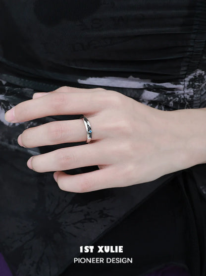 Stylish hand wearing eroded earth couple rings designed by 1STXULIE for modern couples