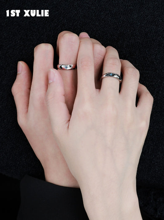 Stylish 1ST XULIE eroded earth couple rings on hands, symbolizing unity and connection