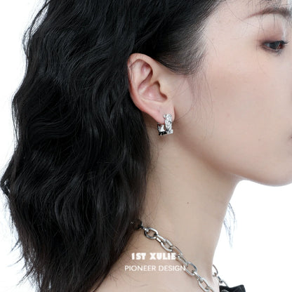 Stylish frosted geometric earrings displayed on model's ear for modern fashion look