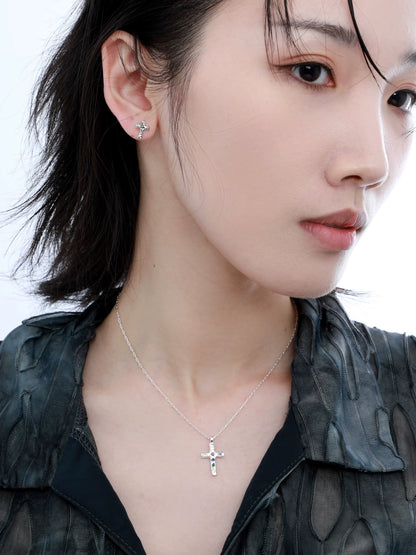 Elegant frozen cross zircon earrings showcased on a model with a stylish outfit