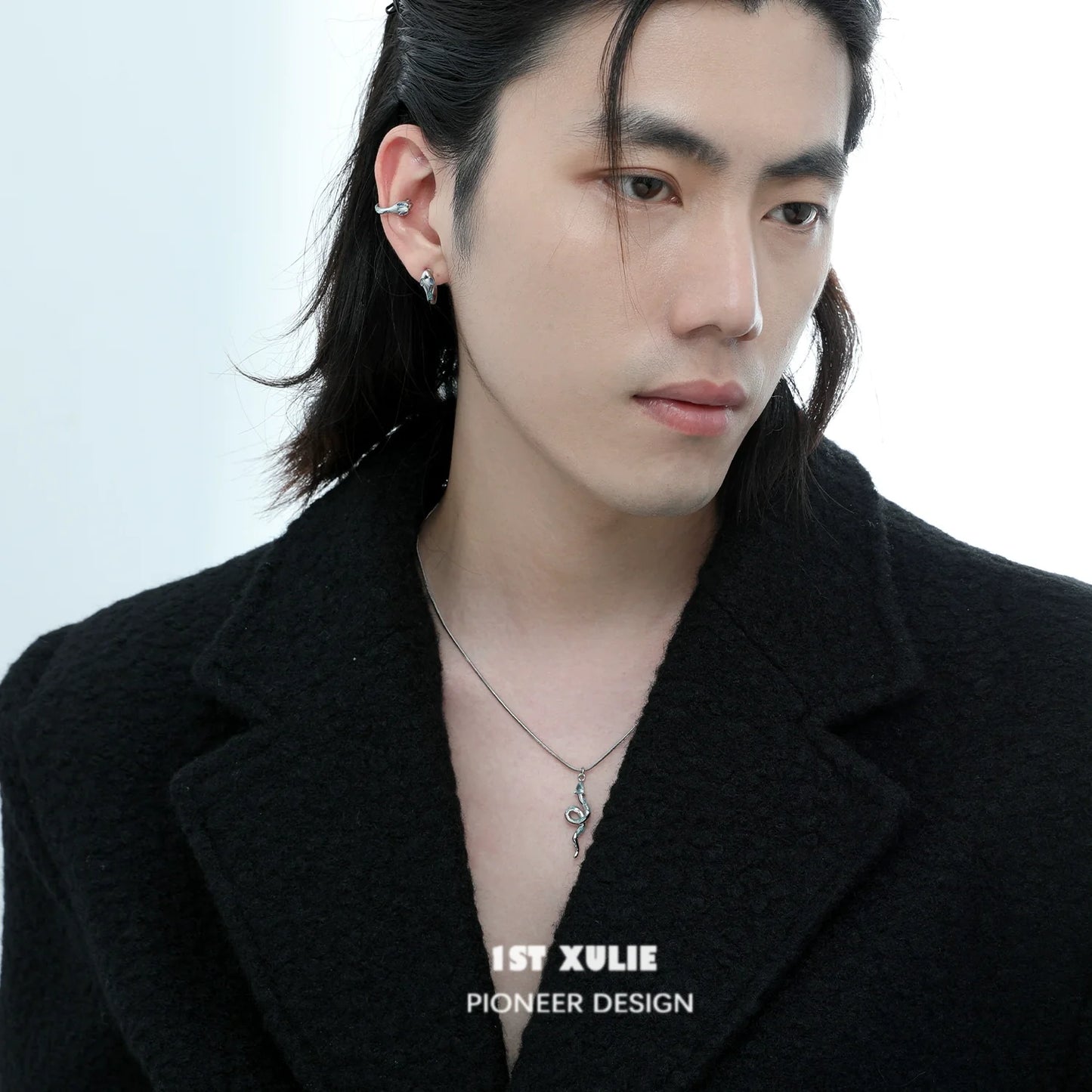 Stylish man wearing a frozen snake silver necklace with a modern outfit for a trendy look