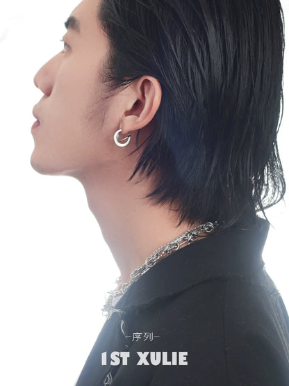 Stylish model showcasing futuristic silver geometric earrings for a modern look