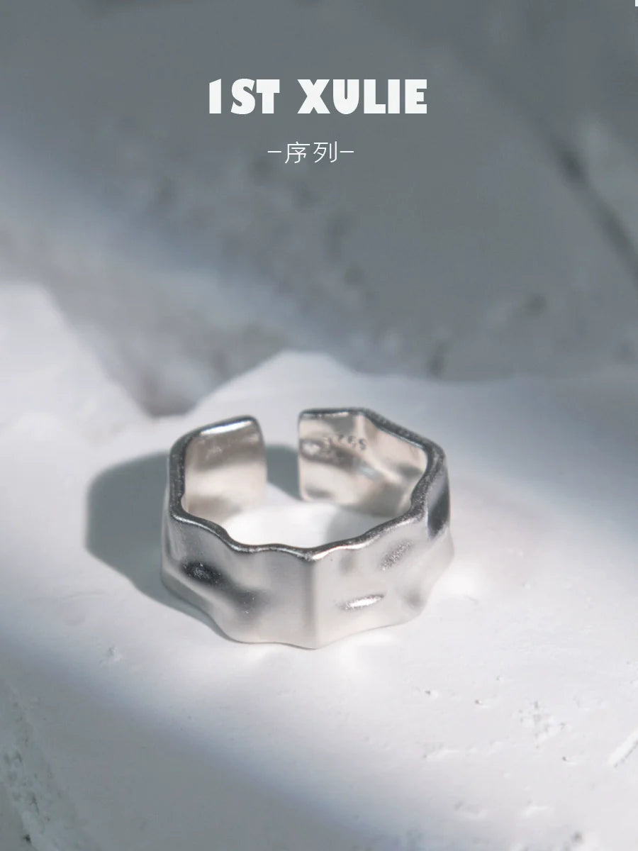 Futuristic silver ring with a unique, textured design, perfect for modern fashion enthusiasts