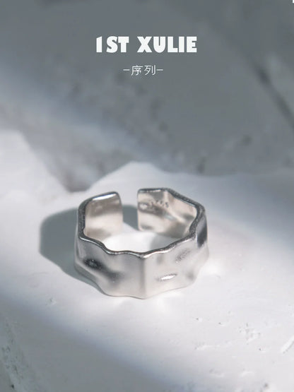 Futuristic silver ring with a unique, textured design, perfect for modern fashion enthusiasts