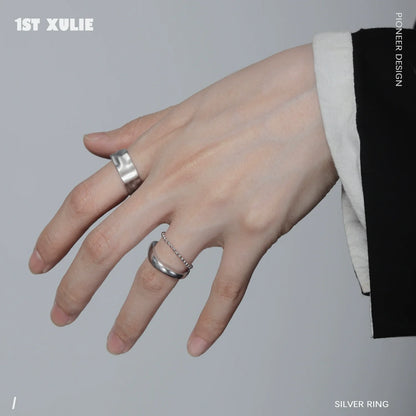 Futuristic silver ring worn on a stylish hand featuring a modern design and unique details