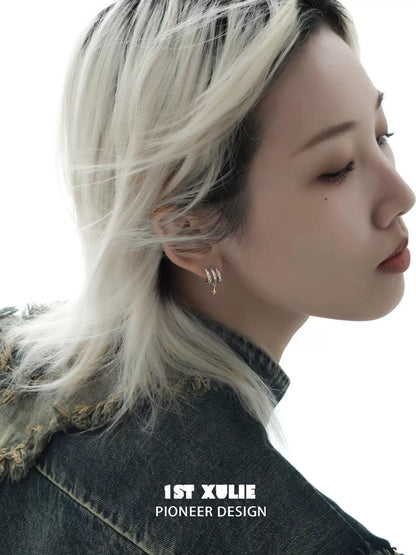 Stylish galactic star earrings showcased on a model with flowing hair against a white background