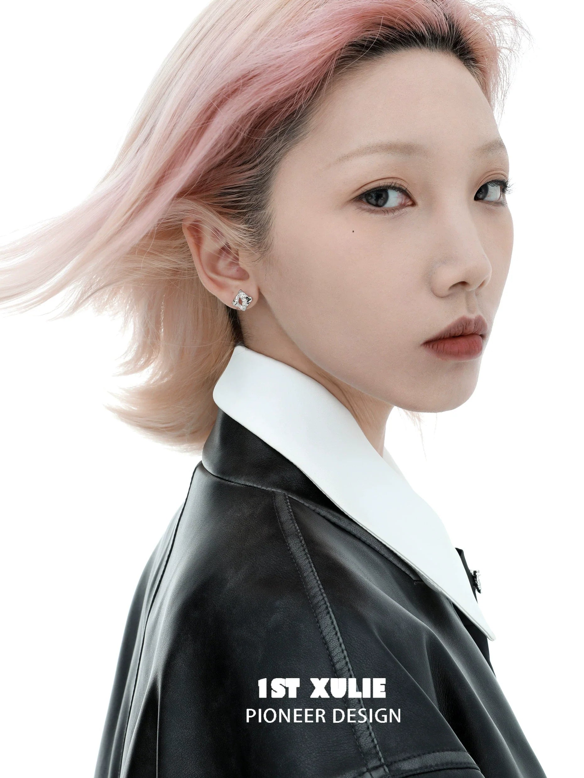 Model wearing geometric silver earrings showcasing modern design and elegance
