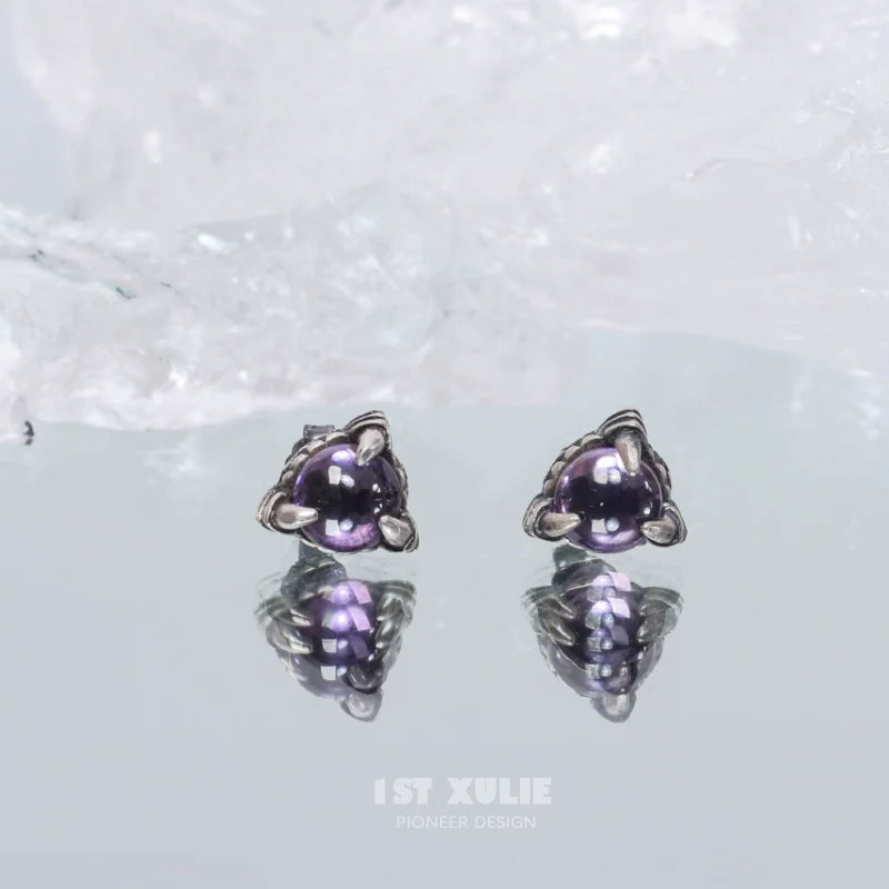 Gothic amethyst stud earrings featuring a unique design with reflective surfaces