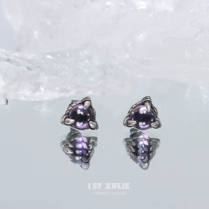 Gothic amethyst stud earrings featuring a unique design with reflective surfaces