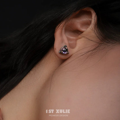 Gothic amethyst stud earrings showcased on a model's ear, perfect for statement jewelry lovers