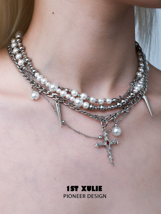 Gothic cross pearl necklace layered with silver spikes and chains for stylish gothic fashion