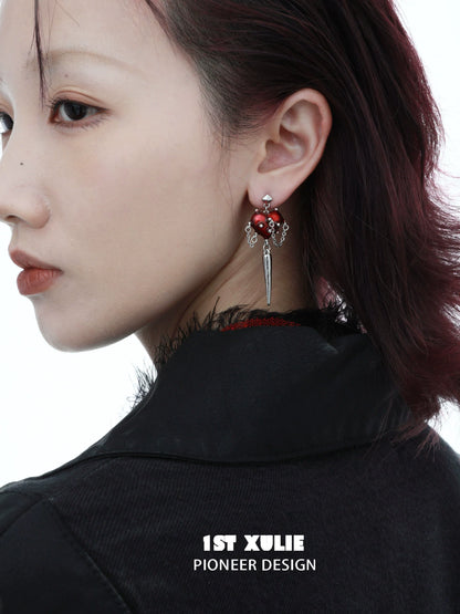 Fashionable gothic heart earrings featuring red hearts and silver spikes for a bold statement