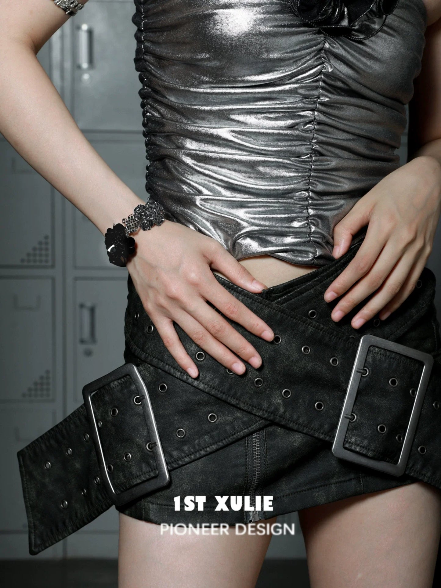Model wearing a gothic rose bracelet paired with a silver top and black belt for a stylish look