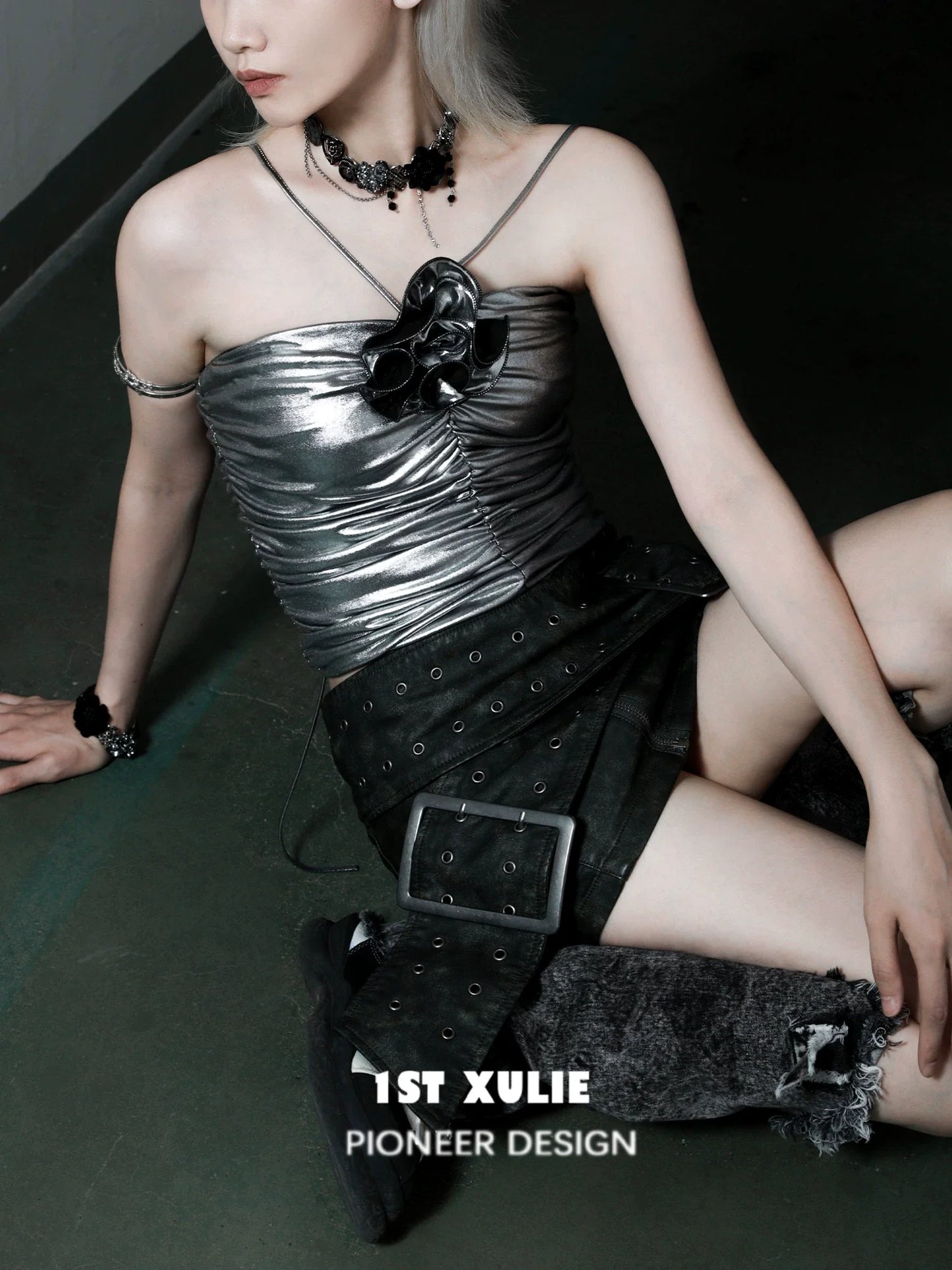 Stylish model wearing a gothic rose clavicle necklace with a metallic top and black skirt for a bold look