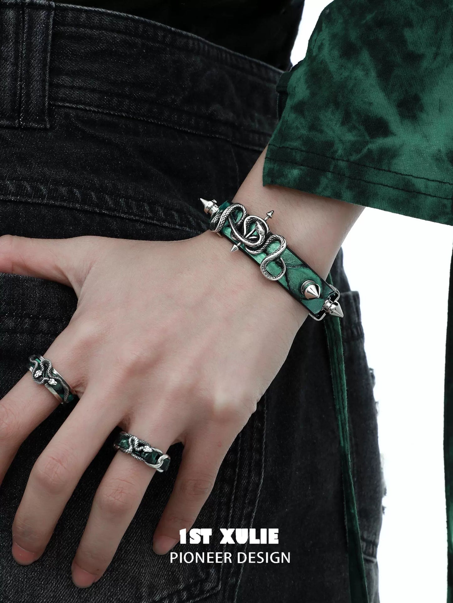 Gothic snake bracelet with intricate design and silver accents, worn on a hand against a dark background