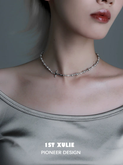 Gray pearl silver double layer necklace featuring a delicate cross accent worn elegantly