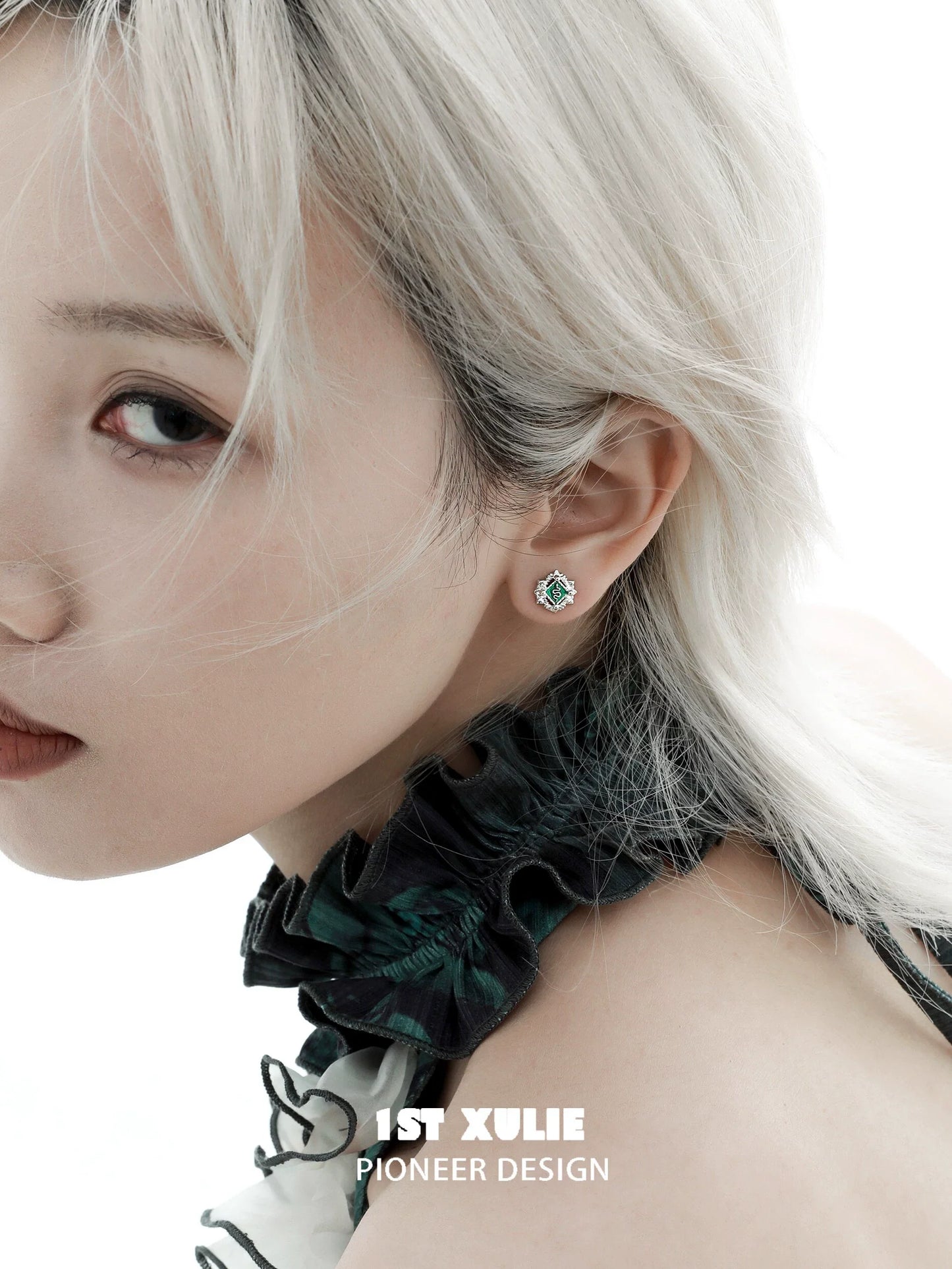 Elegant model showcasing green serpent ear cuffs designed by 1ST XULIE for a chic look
