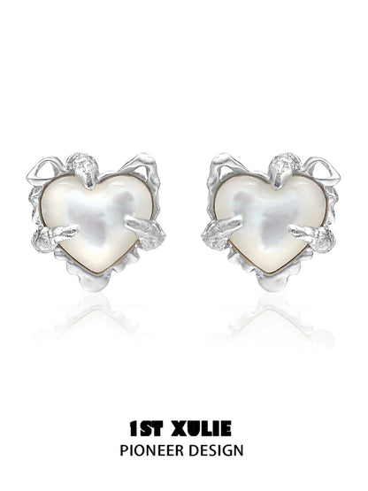 Silver heart ear clips for women with a unique pioneer design featuring a pearl center
