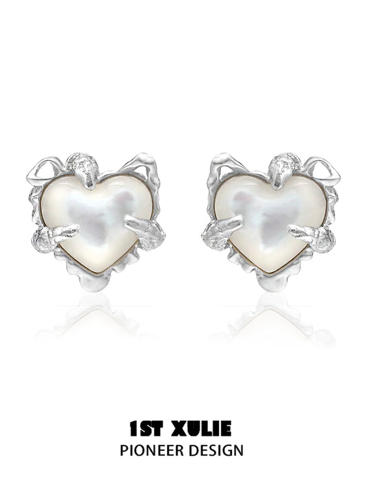 Silver heart ear clips for women with a unique pioneer design featuring a pearl center