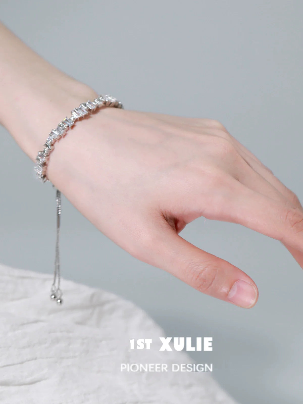 Elegant hand wearing an Iceland zircon star bracelet, showcasing its shimmering beauty and delicate design.