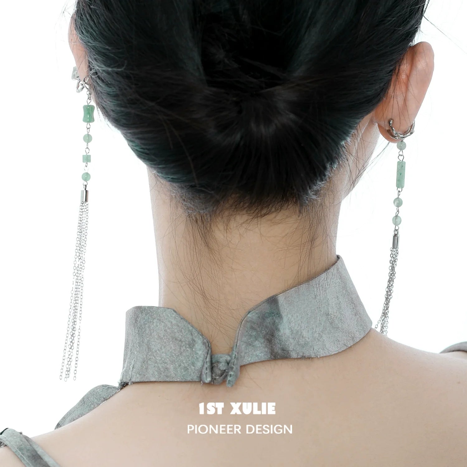 Elegant jade cascade ear clip with delicate chain detail, styled for a chic look