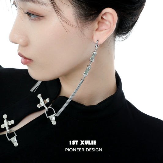 Elegant jade tassel earrings featured on a model with a sleek hairstyle and modern outfit