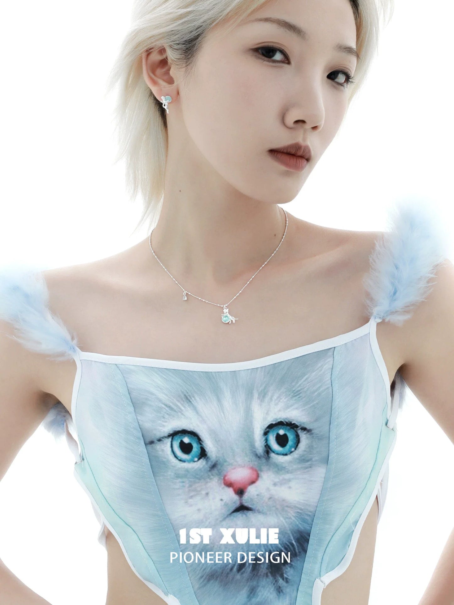 Model wearing a stylish kitten silver necklace with a sparkling charm and a cat-themed outfit