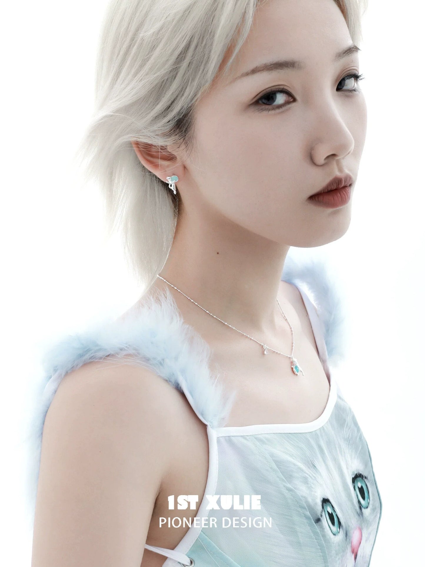 Model wearing a kitten silver necklace paired with stylish earrings for a trendy look