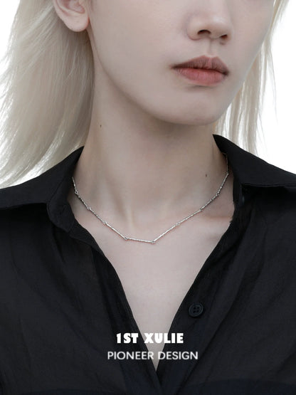 Minimalist bamboo necklace from 1STXULIE featuring a sleek and modern design worn on a model