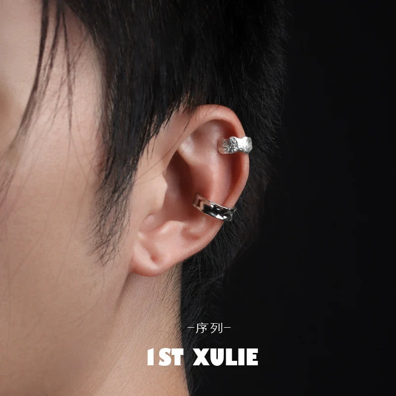 Minimalist frosted ear cuffs displayed on a model's ear showcasing sleek design and modern style