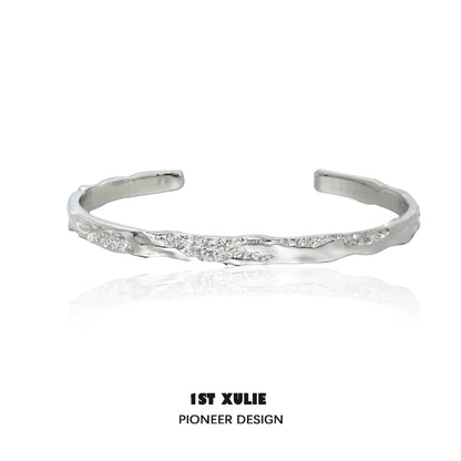 1ST XULIE minimalist silver bracelet with a sleek, modern design and subtle texture