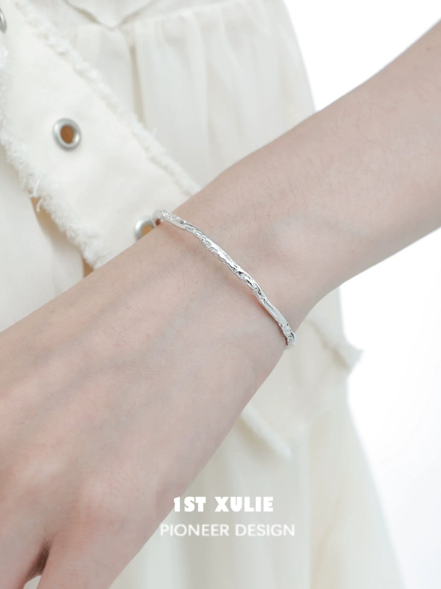 Stylish minimalist silver bracelet featuring a sleek design, perfect for everyday wear