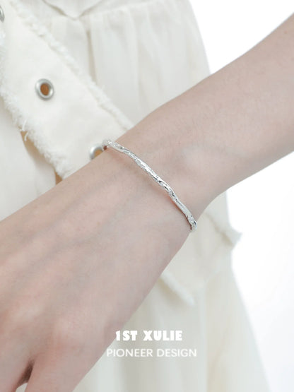 Stylish minimalist silver bracelet featuring a sleek design, perfect for everyday wear