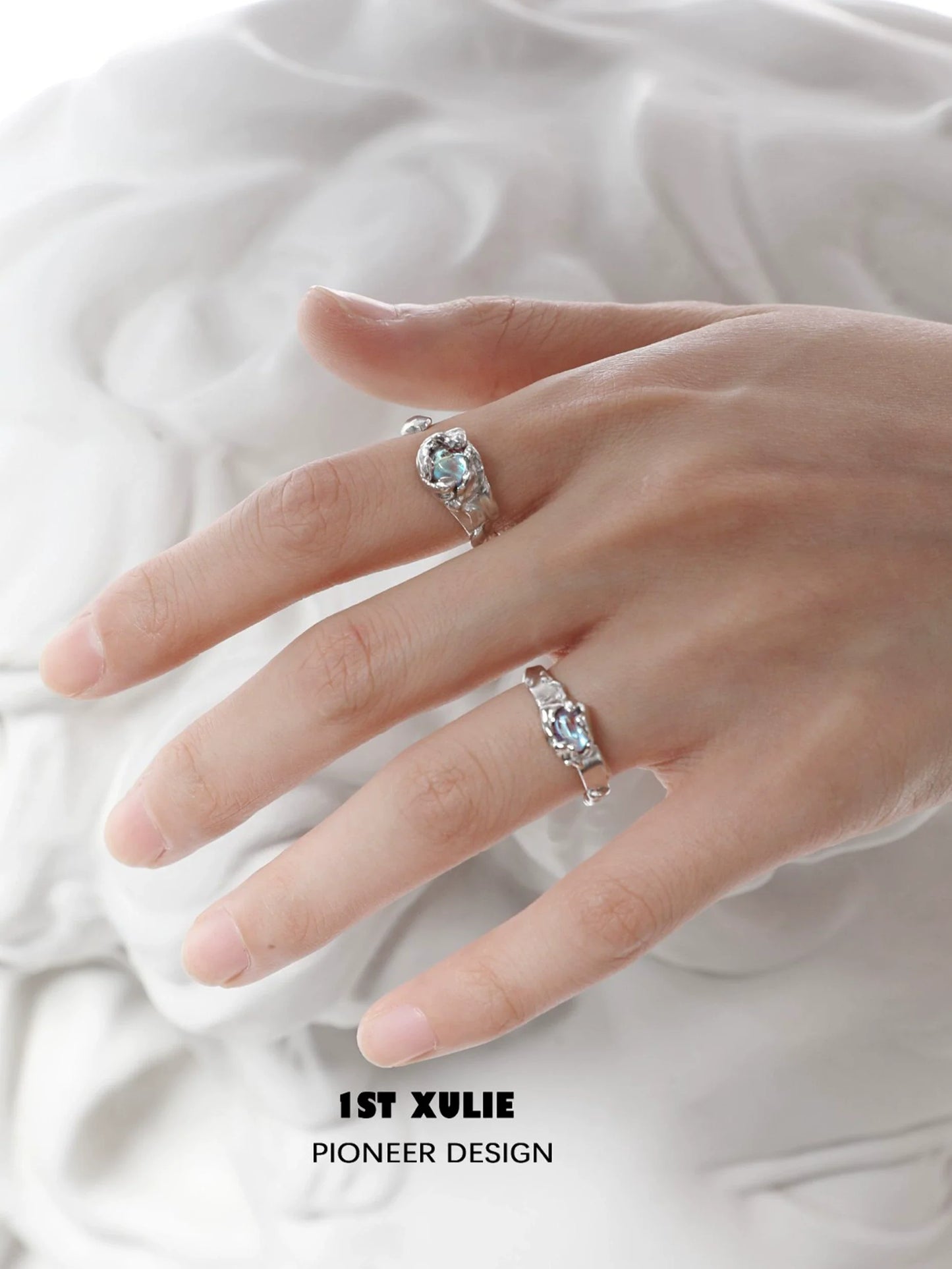 Elegant 1STXULIE moonstone silver ring displayed on a model's hand showcasing its unique design