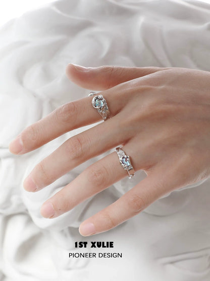 Elegant 1STXULIE moonstone silver ring displayed on a model's hand showcasing its unique design