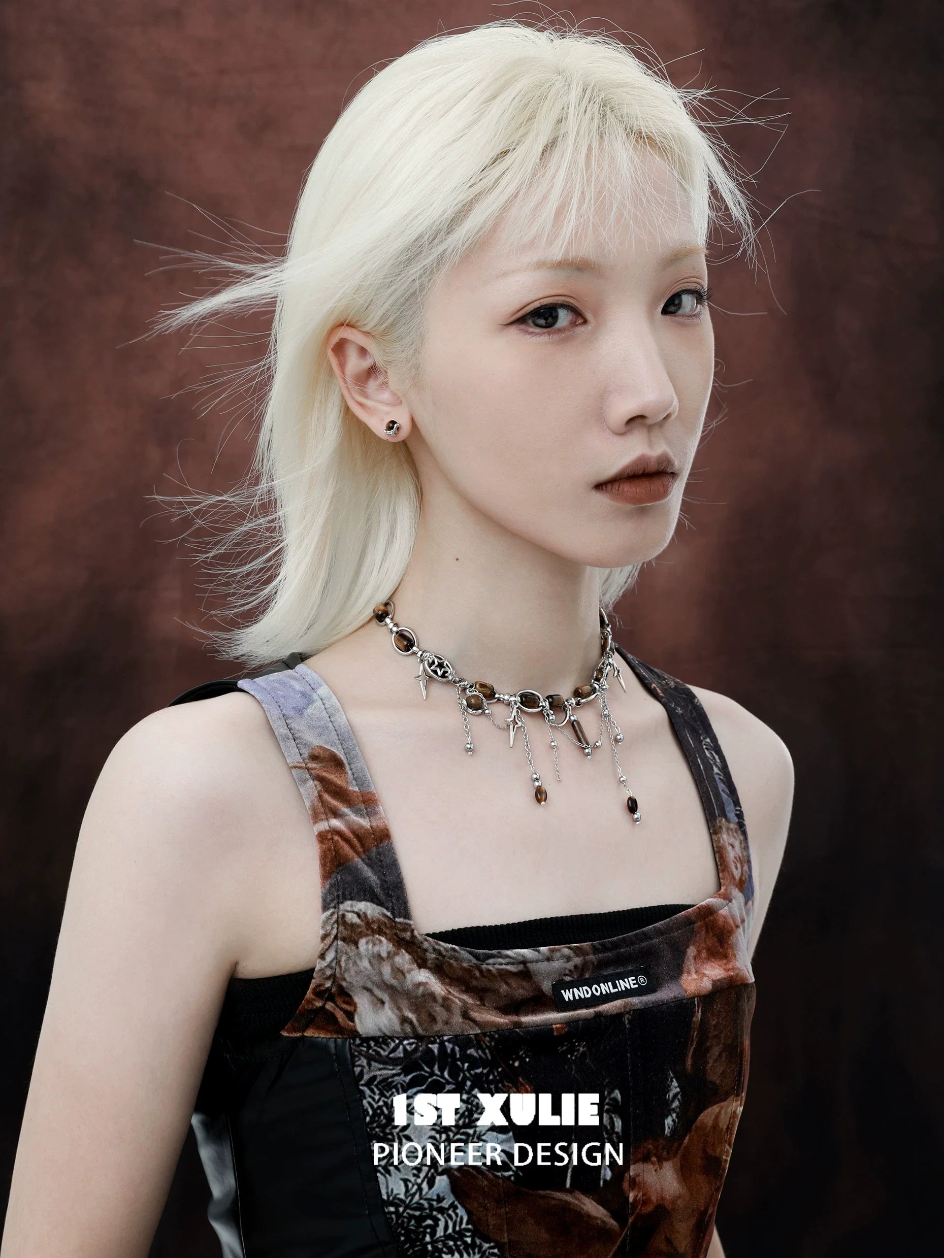 Model wearing 1STXULIE mystic eye earrings, showcasing a chic and modern design against a dark backdrop.