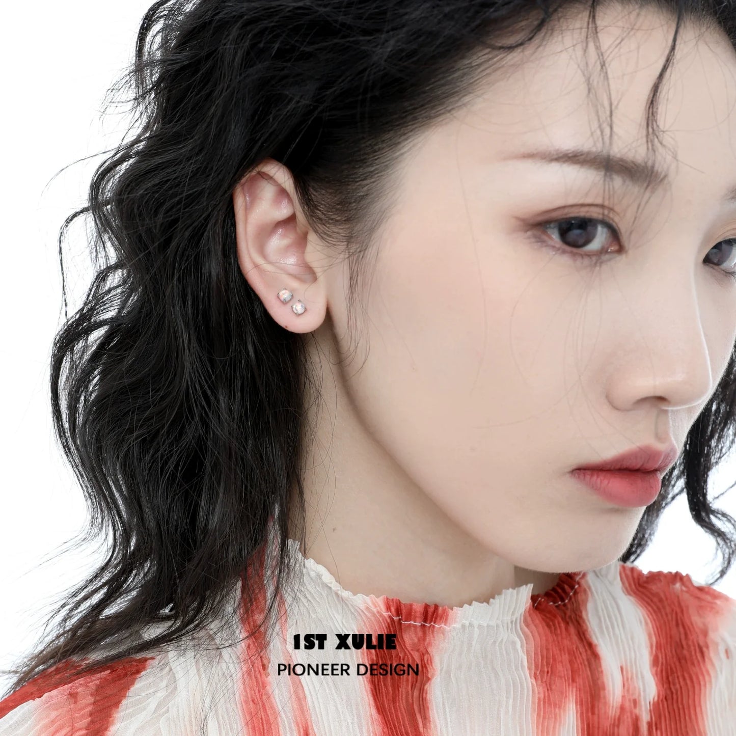 Elegant 1STXULIE opal stud earrings displayed on a model with wavy hair in a soft color palette