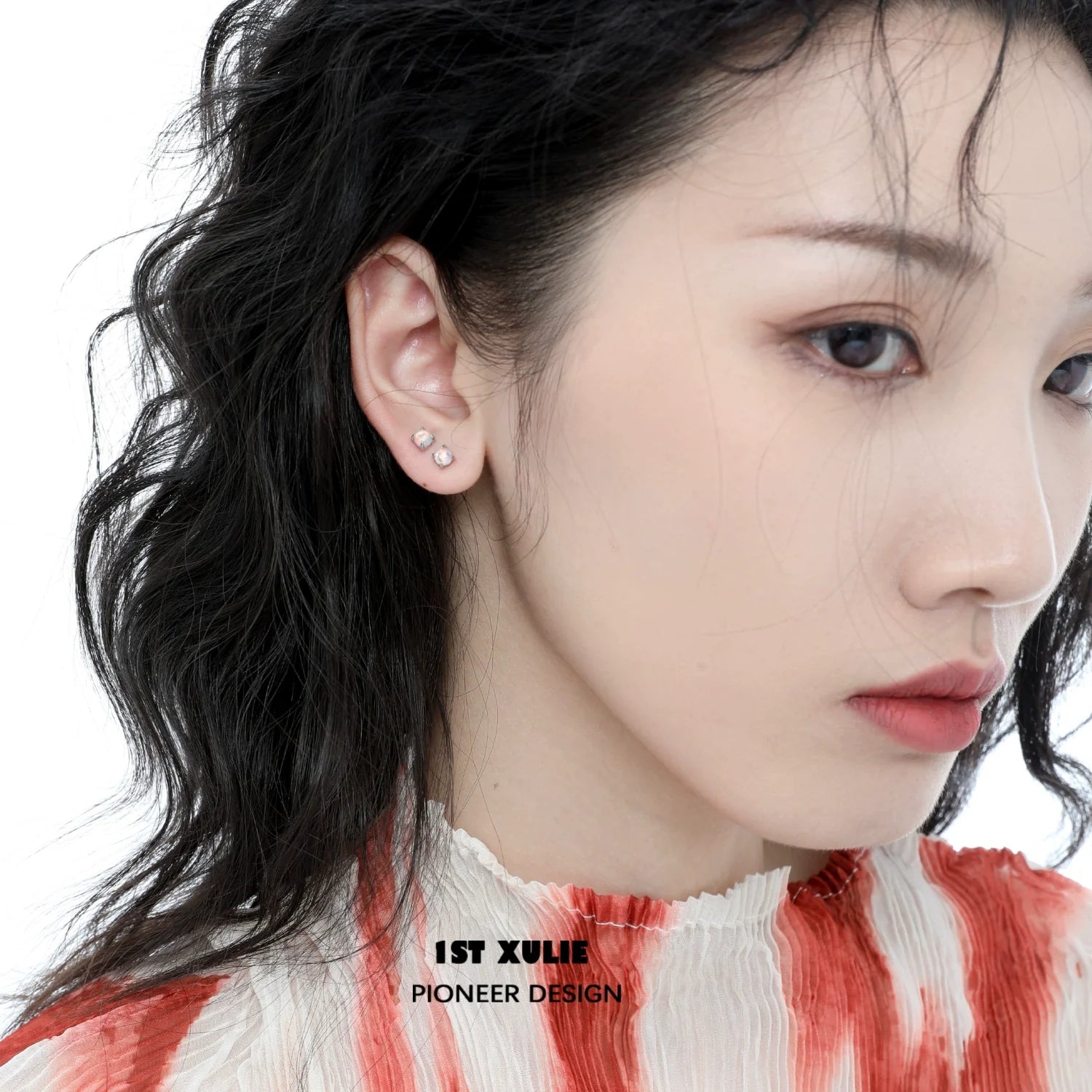 Elegant 1STXULIE opal stud earrings displayed on a model with wavy hair in a soft color palette