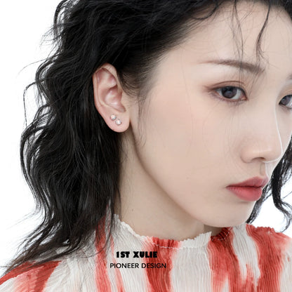 Elegant 1STXULIE opal stud earrings displayed on a model with wavy hair in a soft color palette
