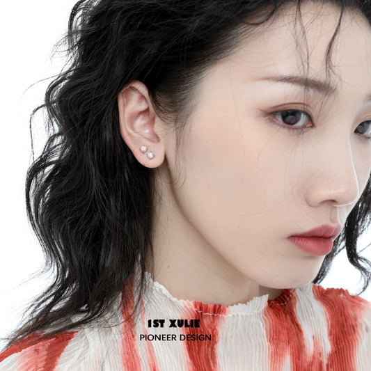 Elegant 1STXULIE opal stud earrings displayed on a model with wavy hair in a soft color palette