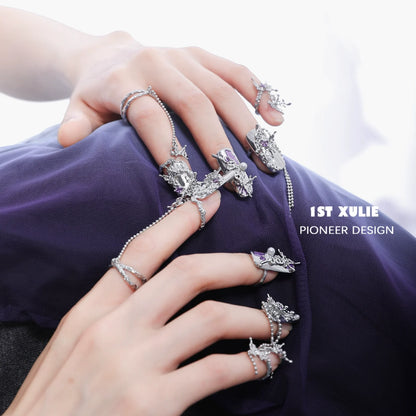 Purple butterfly nail rings with intricate designs showcased on manicured hands