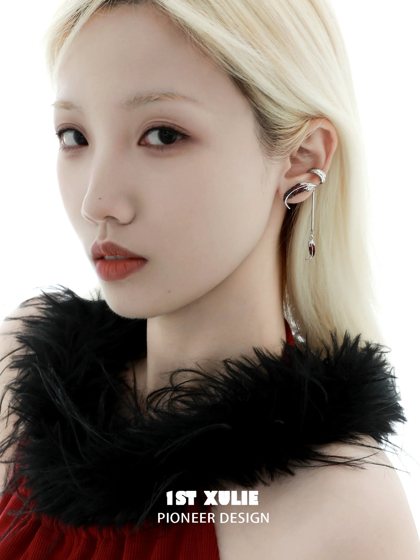 Stylish model wearing red crane feather ear cuffs by 1STXULIE for a unique fashion statement