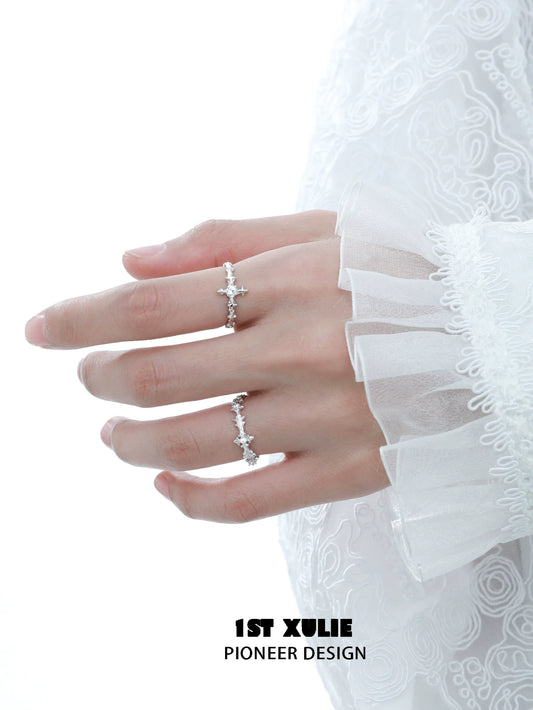 Elegant silver cross couple rings showcased on a hand with delicate lace sleeves
