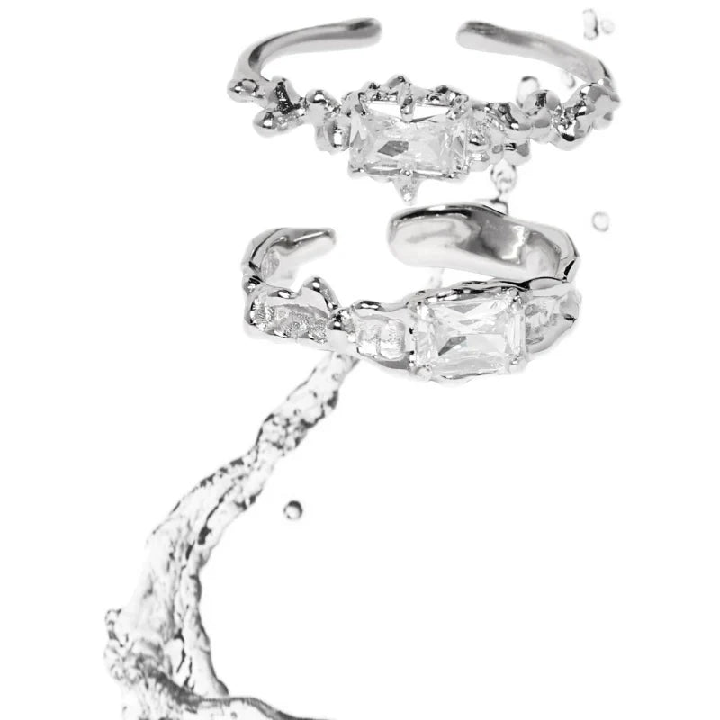 Two elegant silver crown couple rings featuring sparkling clear gemstones for a romantic touch