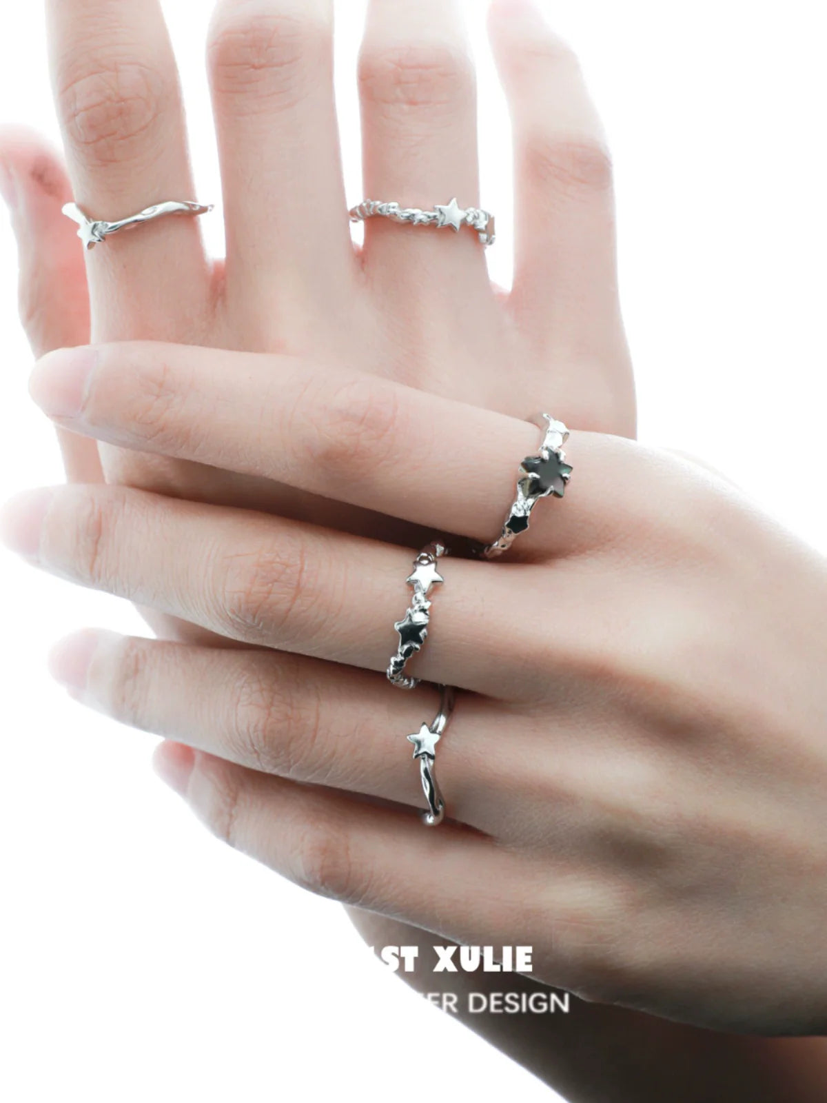 Elegant silver star couple ring collection showcasing delicate star designs on multiple fingers