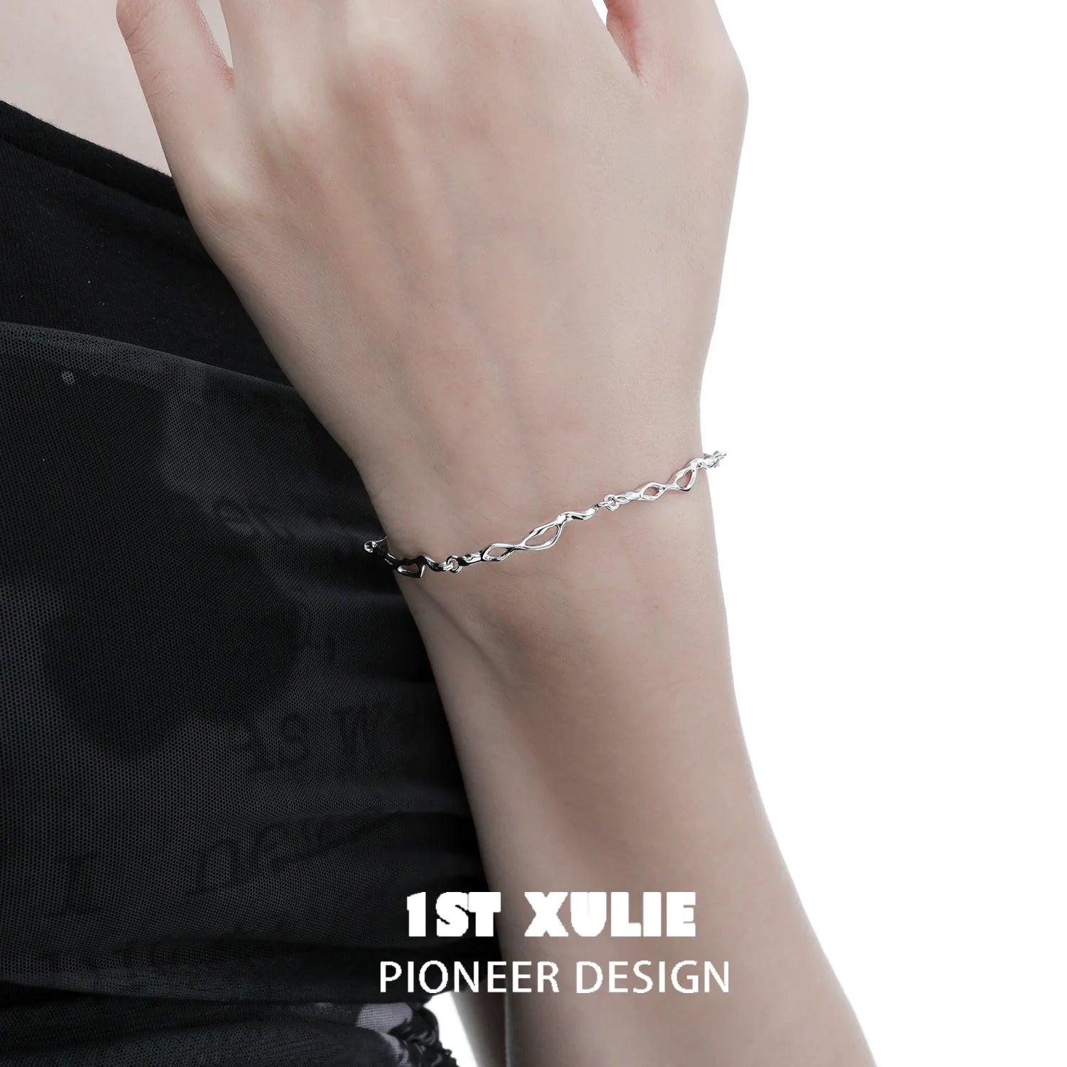 Elegant silver wave chain bracelet from 1ST XULIE showcasing a modern design on a woman's wrist