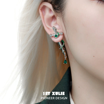 Slytherin inspired cross earrings with green gemstones, perfect for fans of the Slytherin house
