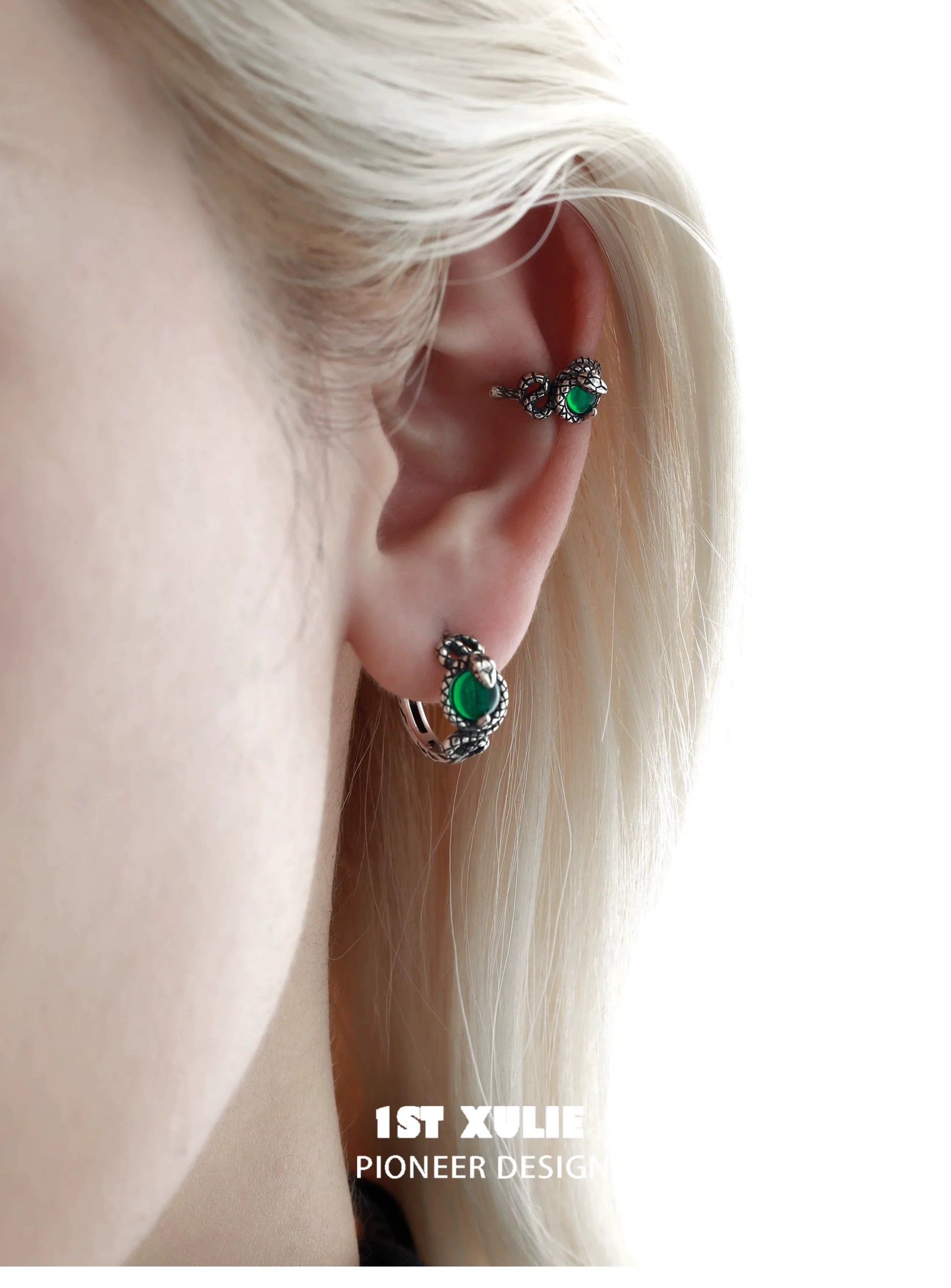 Slytherin snake ear cuff in silver with green accents worn on a model's ear