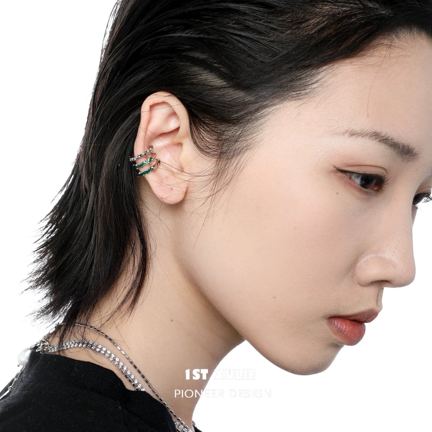 Slytherin snake ear cuff in green and silver, elegantly worn on a model's ear