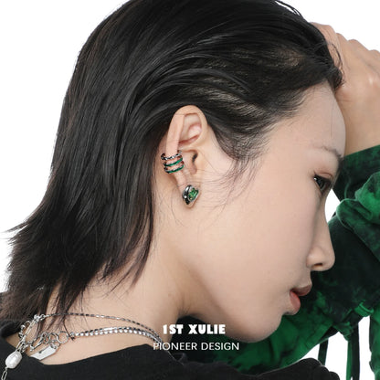 Slytherin snake ear cuff in green and silver worn by a model showcasing unique jewelry design